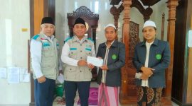 Manager PLN UP3 Madura Fahmi Fahresi menyerahkan bantuan secara simbolis kepada guru di Ponpes Nasyrul Ulum Pamekasan.