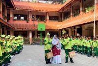 Kepala SDI Al-Munawwarah, Dedeh Rosidah, S.Pd foto bersama siswa pada peringatan Hari Anak Nasional. (LAILIYATUN NURIAH / KLIKMADURA)