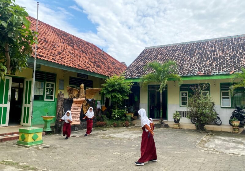 Siswi SDN Jungcancang 3 berada di halaman sekolahnya. (DOK. KLIKMADURA)