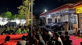 Mahasiswa dan ojol saat menggelar aksi damai di depan Mapolres Sampang. (IBNU ANSORI / KLIKMADURA)