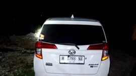 Mobil merek Sigra di sekitar mayat laki-laki dengan kondisi tubuh penuh luka dan terbakar di Desa Lesong Daya, Kecamatan Batumarmar, Pamekasan. (ISTIMEWA)