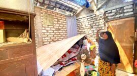 Hasanah menunjukkan rumahnya yang dirusak di Jalan Purba, Nomor 96, Kelurahan Barkot, Kota Pamekasan. (DOK. KLIKMADURA)
