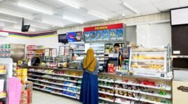 Kasir Indomaret di Jalan Pintu Gerbang, Kelurahan Bugih, Pamekasan melayani pembeli. (LAILIYATUN NURIYAH/KLIK MADURA)