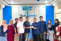 Ketua Jurnalis Muda Pamekasan (JMP), Luthfiadi menyerahkan kue tar kepada Pemred Klik Madura, Prengki Wirananda. (KLIKMADURA)