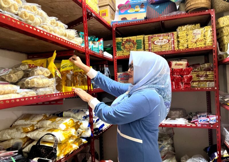 Pedagang di Pasar Kolpajung menata minyak di salah satu kios. (LAILIYATUN NURIYAH / KLIKMADURA)