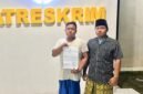 Korban dugaan penganiayaan, Ach Rizki Duwi Purnomo saat menunjukkan surat tanda terima laporan di polres Pamekasan. (KLIKMADURA)