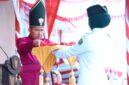 Bupati Sumenep Dr. Achmad Fauzi Wongsojudo menyerahkan sang saka merah putih kepada petugas pengibar bendera. (KLIKMADURA)