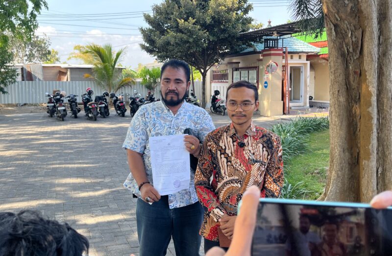 Penasihat Hukum korban, Khairul Umam bersama rekannya saat menunjukkan surat laporan polisi. (MOH. IQBALUL KHAVEI MZ / KLIKMADURA)