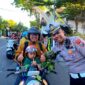 Polantas Polres Sampang foto bersama pengendara yang tertib berlalu lintas. (KLIKMADURA)