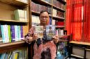 Dosen Sastra Prodi Pendidikan Bahasa Indonesia, Unira, Muhammad Tauhed Supratman memegang buku karyanya berjudul Lukamu Abadi dan buku Kumpulan Puisi Ranjang Poskolonial karya Royyan Julian di Perpustakaan Unira, Senin (12/10/2026) (LAILIYATUN NURIYAH/KLIK MADURA).