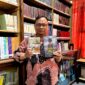 Dosen Sastra Prodi Pendidikan Bahasa Indonesia, Unira, Muhammad Tauhed Supratman memegang buku karyanya berjudul Lukamu Abadi dan buku Kumpulan Puisi Ranjang Poskolonial karya Royyan Julian di Perpustakaan Unira, Senin (12/10/2026) (LAILIYATUN NURIYAH/KLIK MADURA).